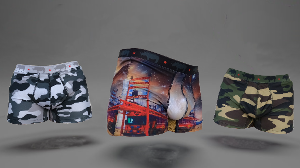 Three pairs of camouflage-patterned boxer briefs on a gray background